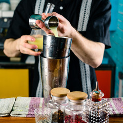 bartender at the bar making a cocktail