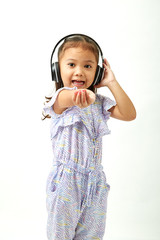 little girl listening to music on headphones