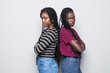 © F8  \ Suport Ukraine - Portriat of two negative african women standing with arms crossed after quarrel isolated over white background