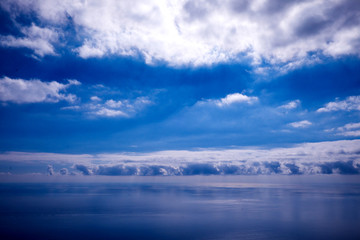  blue sky, white clouds and calm blue sea