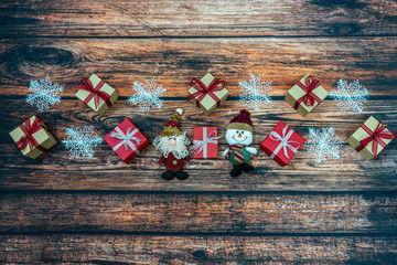 Christmas gift boxes with snowflake flame on wooden backg