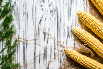 corn, greenery on cloth on white background