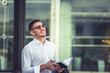 © qunica.com - Serious young man doing business plan while writes with pen in his notes