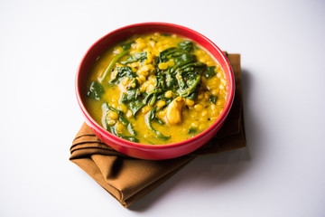 Dal Palak or Lentil spinach curry - popular Indian main course healthy recipe. served in a karahi/pan or bowl. selective focus