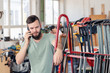 © Firma V - worker in a carpenter's workshop is calling