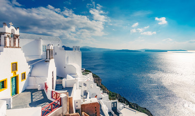 Fototapete - Architecture of Oia village, Santorini island in Greece, on a sunny day with dramatic sky. Scenic travel background.