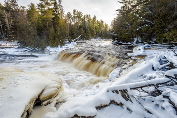 winter waterfall background. the lower falls at tahquamenon fall state park in northern michigan rus