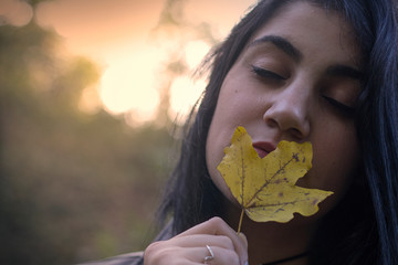 Girl with an autumn leaf