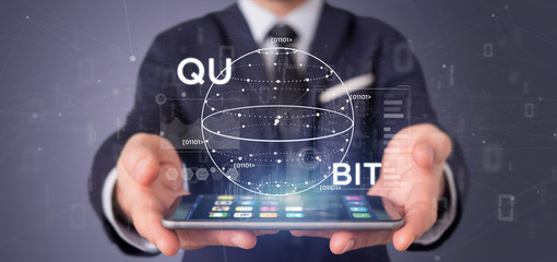 Poster - Businessman holding Quantum computing concept with qubit icon 3d rendering
