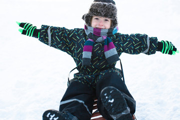 little cute boy in winter clothers outside on snow, lifestyle pe