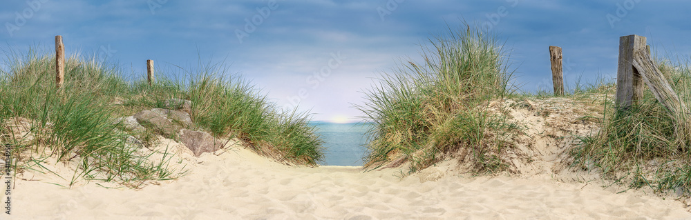 beautiful sunset by the sea, dune at the ocean with grasses and wood plows - obrazy, fototapety, plakaty 