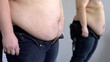 © motortion - Overweight male looking at fat belly mirror reflection, obesity health problem