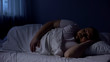 © motortion - Plump man sleeping in bed, relaxing at night on comfortable mattress, rest
