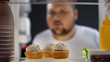 © motortion - Hungry fat man looking at cream cakes in fridge at night, diabetes risk, sugar