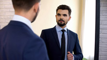 Businessman Is Suit Looking In Mirror Before Important Meeting, Checking Outfit