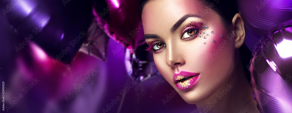 Beauty fashion model girl creative art makeup with gems. Woman face over purple, pink and violet air balloons background - obrazy, fototapety, plakaty 