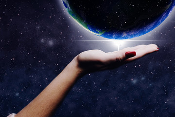 Leinwandbilder - Protect our world in woman hands and nebula dust. Mixed media .