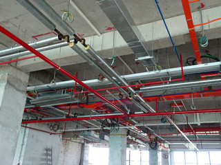 Air condition duct and other services above ceiling level coordinated and installed by construction workers  at the construction site 