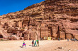 © LMspencer - Petra, Jordan - Feb 15th 2018 - A family walking in front of a mountain with carving temples in Petra in Jordan