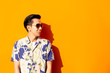 Fashion asian man with sunglasses on colored background.