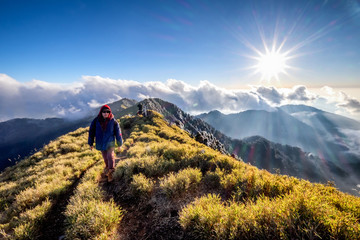A breathtaking landscape in Taiwan. This was taken on top of a mountain. The clouds formation is vast and dramatic. The sun rises above the thick clouds. The image is calm, peaceful and magnificent.