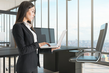 Wall Mural - Pretty businesswoman with laptop