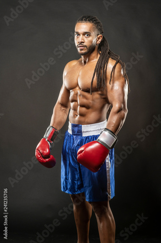 Fotografie, Obraz Muscular African American Black male boxer with dreadlocks hair stands menecenl