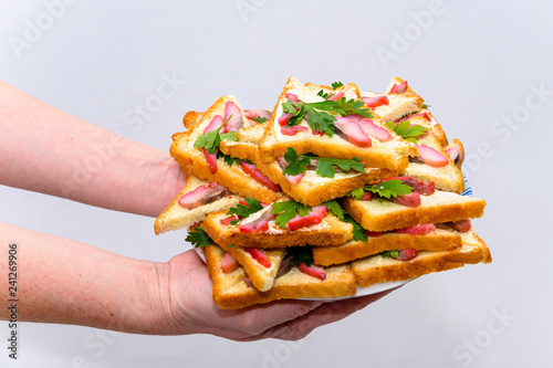 Fotografie, Obraz Sandwiches with butter and red caviar, green salad leaf, on a wooden rustic table