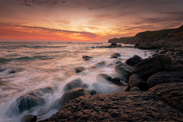 Wall Mural - Seascape during sunrise. Beautiful natural seascape. Sea sunrise at the Black Sea coast. Magnificent sunrise with clouds and fire sun at the beginning of April.