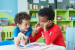 © weedezign - Two boy kid sit on table and reading tale book  in preschool library,Kindergarten school education concept.