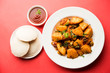 © Arundhati - Masala fried Idlies or Idli fry - south indian Snack made using with leftover idly served with tomato ketchup. selective focus
