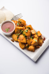 Canvas Print - Masala fried Idlies or Idli fry - south indian Snack made using with leftover idly served with tomato ketchup. selective focus