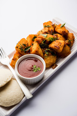 Canvas Print - Masala fried Idlies or Idli fry - south indian Snack made using with leftover idly served with tomato ketchup. selective focus