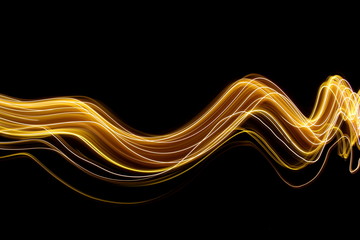 Wall Mural - Light painting photography, gold swirls and waves of vibrant color, long exposure photo of fairy lights against a black background