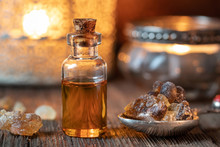 A Bottle Of Frankincense Essential Oil With Frankincense Resin Crystals