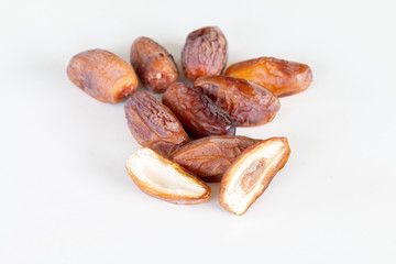 Wall Mural - Close up of dried dates palm fruits on white background