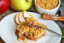 Apple Crumble On With Dish With Spoon And Fresh Green And Red Apple With Cinnamon Stick On Wooden Floor. Easy And Basic Dessert Menu.