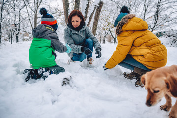 Wall Mural - Family playing in the snow