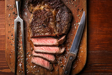 tasty and fresh, very juicy ribbey steak of marbled beef, on a wooden table.