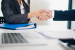 © ijeab - Businessmans handshake after good deal.