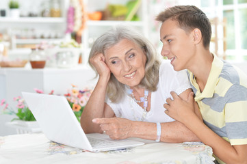 Sticker - Portrait of grandson and grandmother using laptop