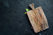 Kitchen wooden board on a stone background. On a black background.