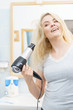© anetlanda - Blonde woman using hair dryer