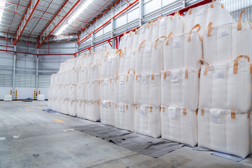 Stacking of bulk cargo in jumbo bags are store in warehouse for distribution to customer, import export logistics business.