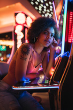 USA, Nevada, Las Vegas, Portrait Of Young Woman At Slot Machine In A Casino
