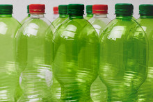 Many Green Plastic Bottles With Caps.
