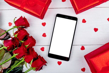 Bouquet of roses, red gift boxes, paper hearts and cellphone with blank screen on white background, copy space. Valentines day, Womens Day, Mothers Day. Top view, flat lay