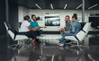 © JonoErasmus - Team of african bussines people sitting in a modern office and talking during an work meeting