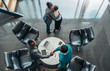 © JonoErasmus - African business colleagues greeting and thanking each other after a successful meeting. Two woman are hugging and two men are shaking hands