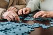 © LIGHTFIELD STUDIOS - cropped view of retired couple playing with puzzles at home